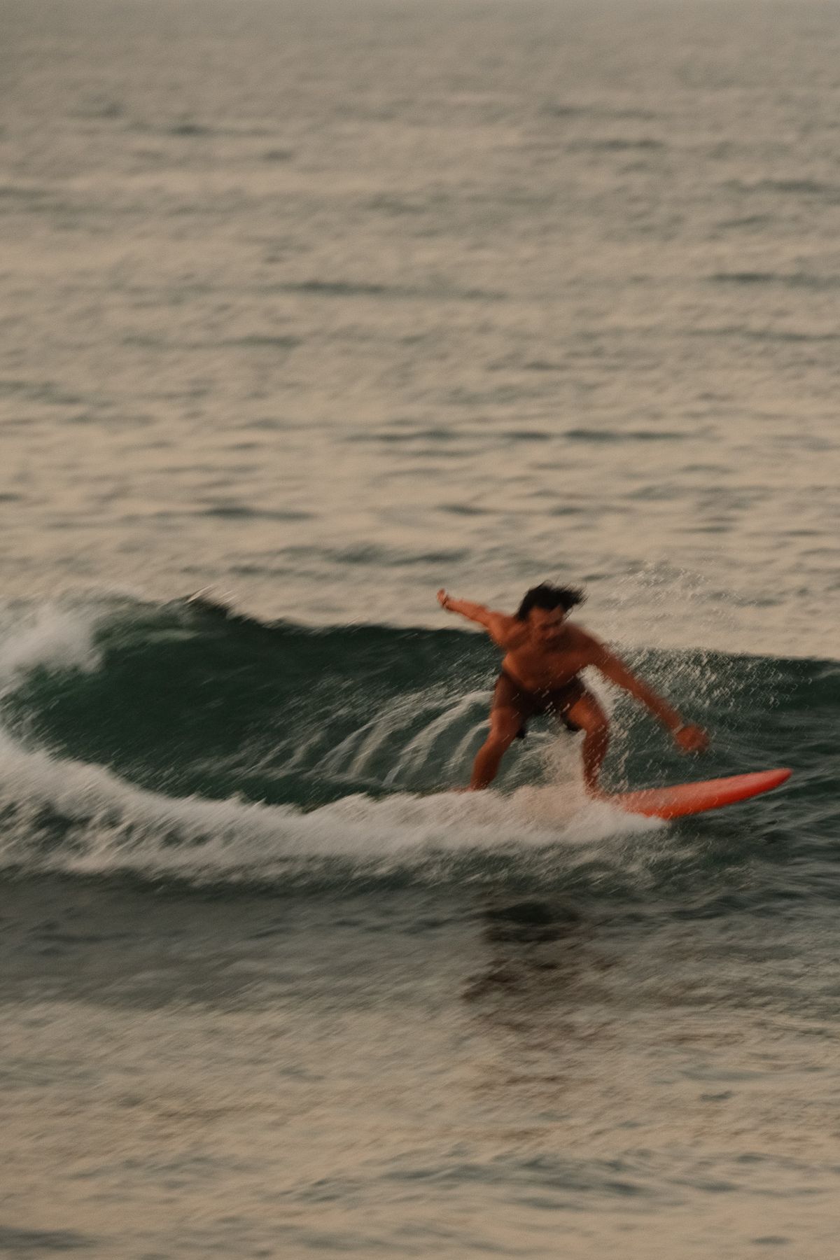 Surfer turning on a wave on an orange board
