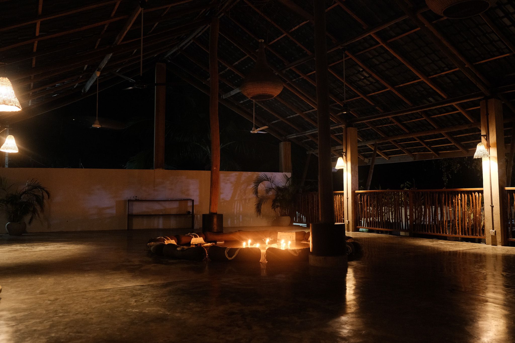 Open shala at night, lit by candles and lamps